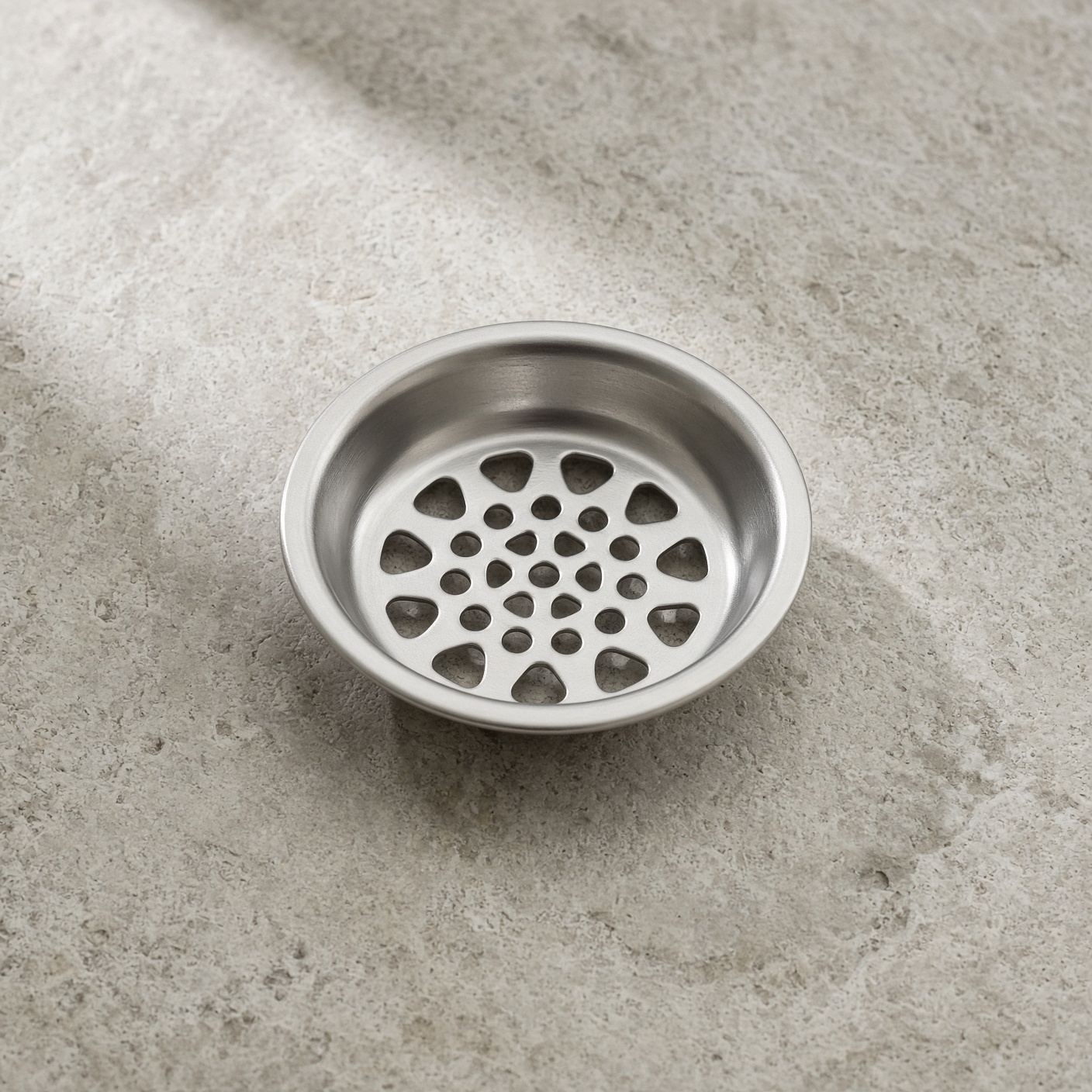 A stainless shower drain catcher.