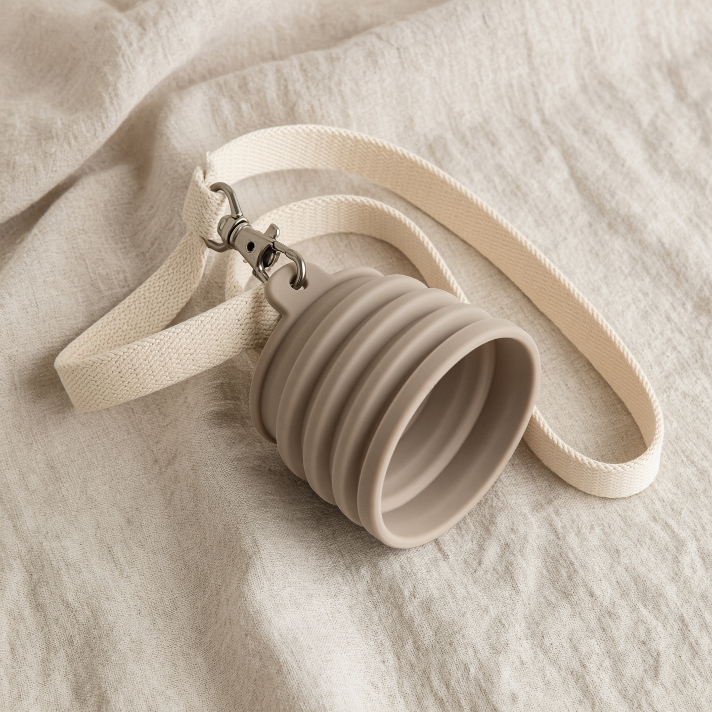 A collapsed silicone bowl clipped to a lead.