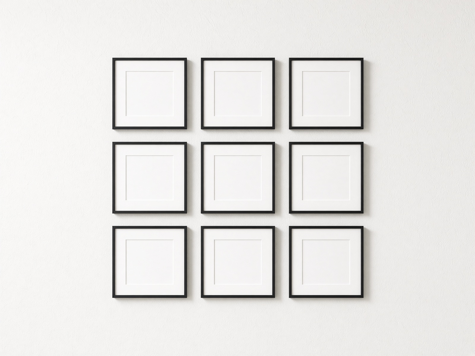 Nine black square frames arranged on a pale wall.